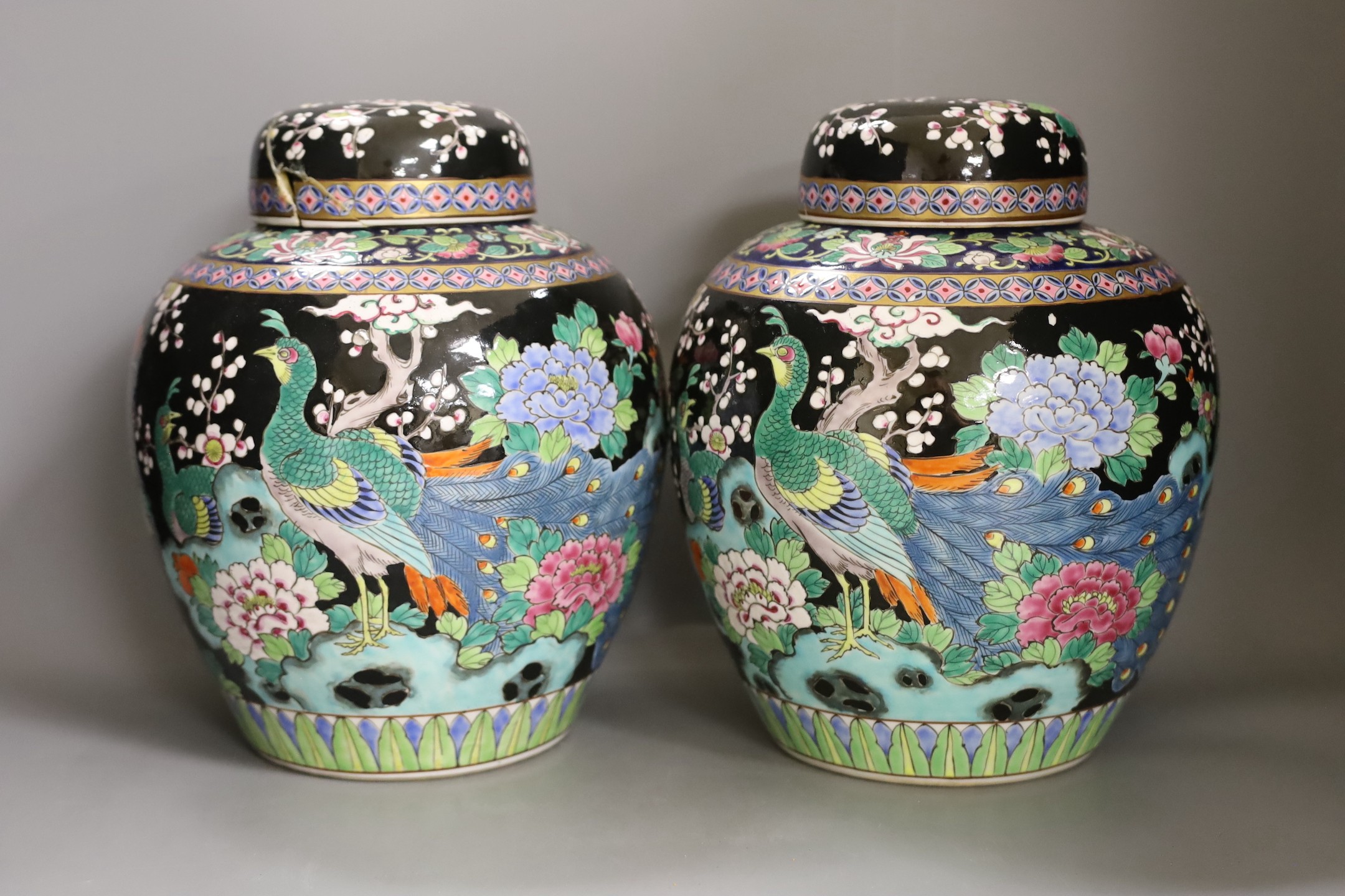 A pair of Japanese famille noire jars and covers, early 20th century, 27cm